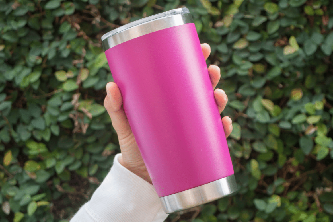 Hand holding a pink insulated cup as an alternative to YETI