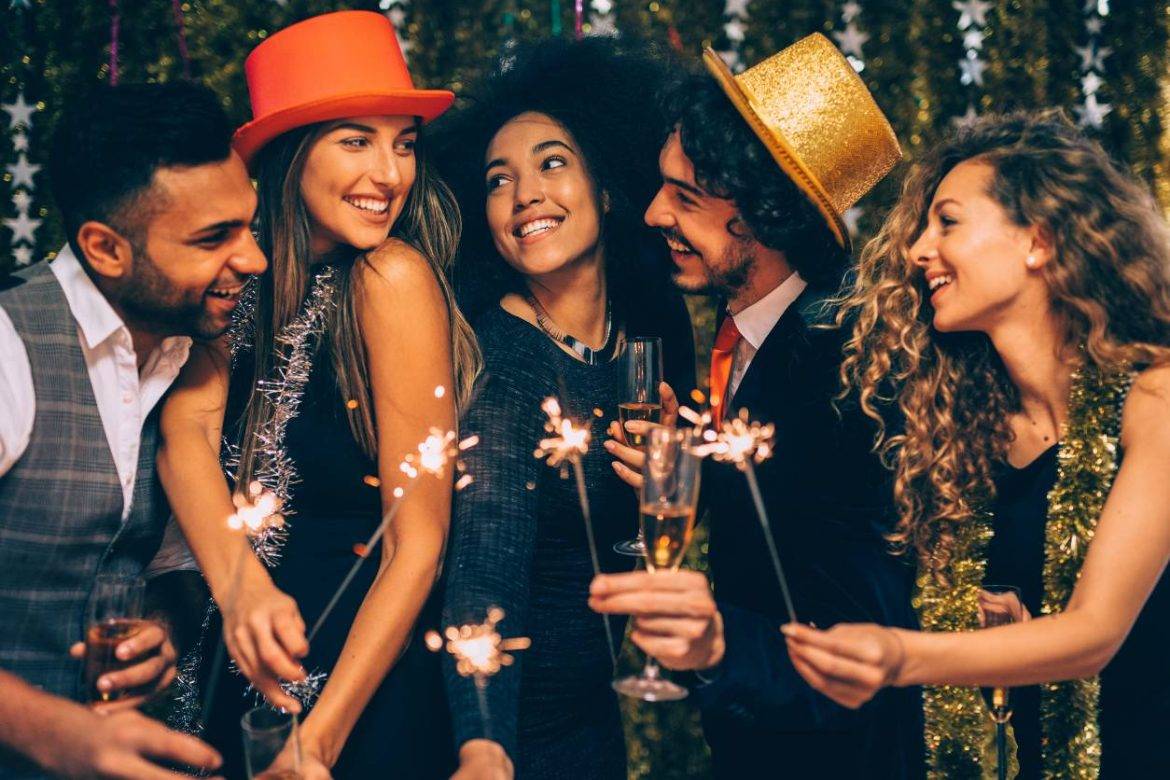 Group of people celebrating New Year's Eve holding cocktails