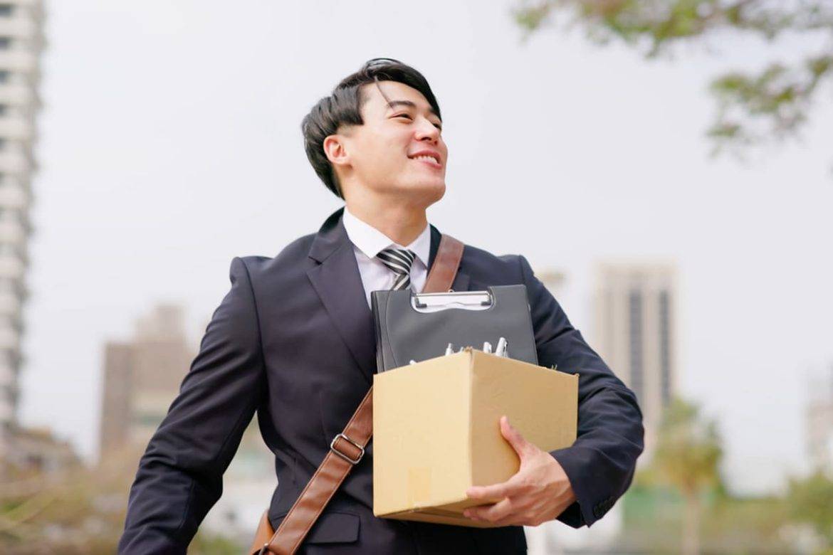 A man holding a box of promotional products