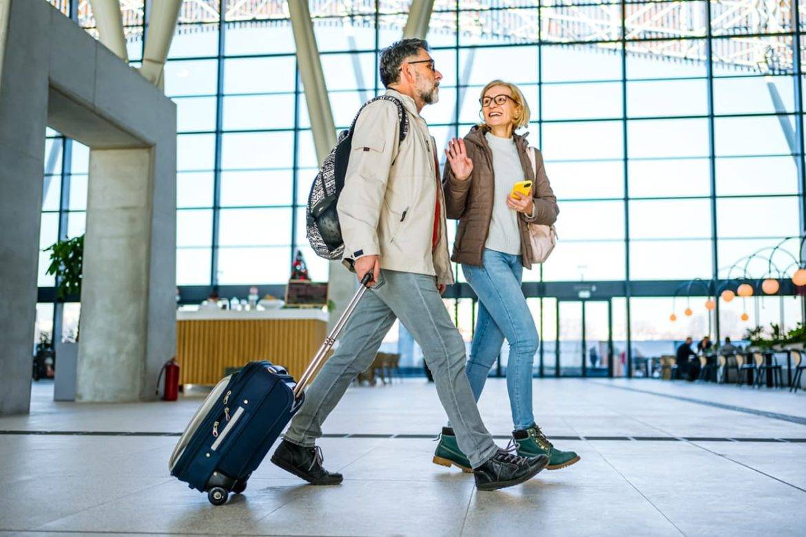 Mature couple of passengers at the train station stock